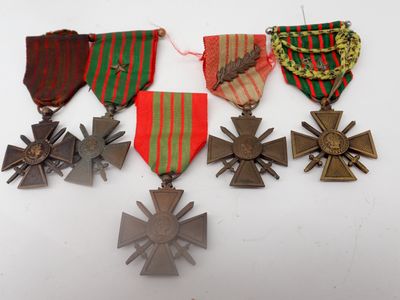 four medals and a cross on a white surface