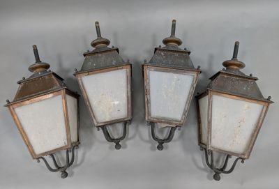 three old fashioned light fixtures mounted on a wall