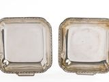 pair of antique silver plated dishes on stands on a white background
