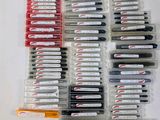 a lot of pens that are sitting on a table