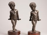pair of antique bronze figurines of a boy and a girl