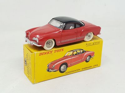 a red toy car sitting on top of a yellow box