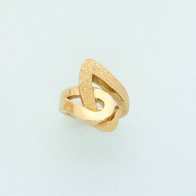an image of a gold ring on a white surface