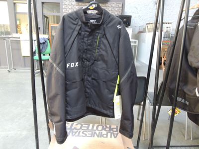 a black jacket hanging on a rack in a store