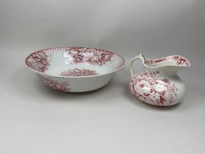 two red and white dishes and a bowl on a white surface