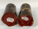 pair of antique tinned wine bottles with labels on them