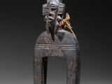 a close up of a statue of a man with a bird on his head