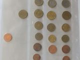 a lot of coins in a plastic container on a table