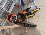 a pile of tools on the floor next to a hand truck