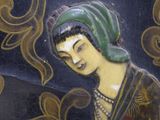 a picture of a woman that is sitting on a plate