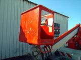 a red crane that is parked in front of a building