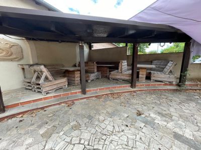 une photo d'un patio avec une table et des chaises