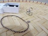 a bracelet, ring, and ring holder on a table