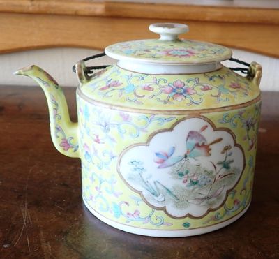 a tea pot sitting on a table in a room