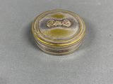 an image of a small silver and gold box with a horse on it
