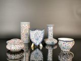 a group of vases and bowls sitting on a table