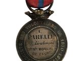 an old medal with a red and blue ribbon on a white background