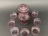 a lot of pink glass cups on the table