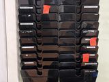a picture of a wall of cell phones and a chair