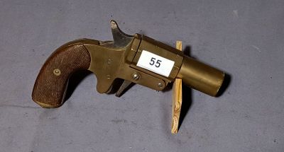 a gun with a wooden handle on a gray surface