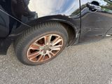 a close up of a black car with a flat tire