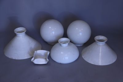 five white vases sitting on a table next to each other