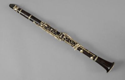 a close up of a clarinet on a gray surface