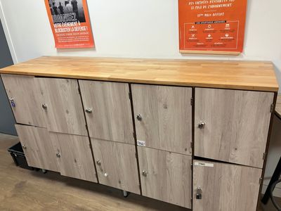 a wooden cabinet with four drawers on wheels in a room