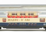 two train cars sitting side by side on a white surface