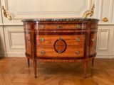 a wooden cabinet with a marble top on a wooden floor