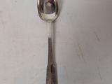 a spoon and a spoon rest on a white surface