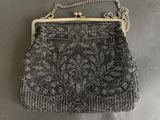 a black and white purse with a chain strap