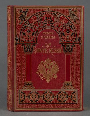 un livre rouge avec des inscriptions dorées et noires