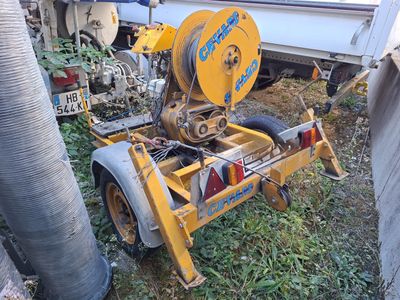a machine that is sitting on the ground next to a truck