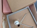 a box with a necklace and a book inside of it