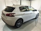 the rear end of a white car in a garage