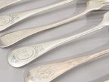 five spoons that are sitting on a table