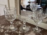 three wine glasses sitting on a table next to a mirror