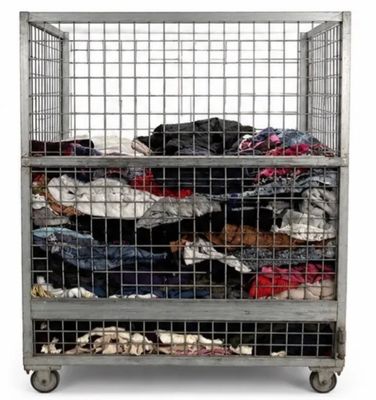 a metal cage filled with lots of clothes on top of it