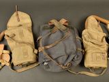three gas masks are lined up in a row on a table
