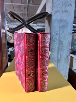 two red books sitting on a yellow table