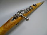 an old gun with a wooden handle on a white surface
