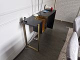 a small table with a laptop on it in a living room