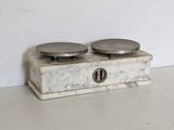 a marble box with two plates on top of it