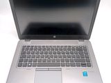 a silver laptop with a blue sticker on the screen