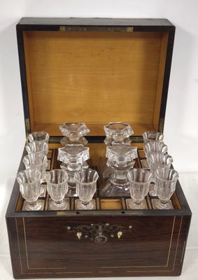 a wooden box that has a set of glasses in it