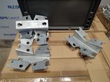 several pieces of metal sitting on top of a cardboard box