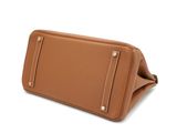 an image of a tan purse with a zipper on the front