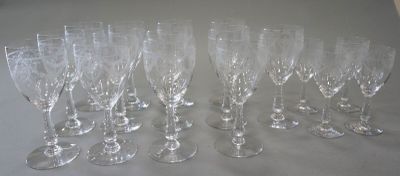 seven empty wine glasses sitting on a table