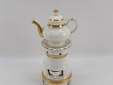 a close up of a white tea pot with gold trim